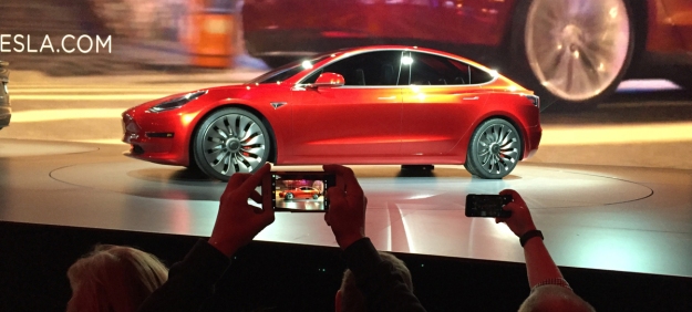 CORRECTS SPELLING OF PHOTOGRAPHER'S LAST NAME TO PRITCHARD, NOT PRICHARD - Tesla Motors unveils the new lower-priced Model 3 sedan at the Tesla Motors design studio in Hawthorne, Calif., Thursday, March 31, 2016. It doesn't go on sale until late 2017, but in the first 24 hours that order banks were open, Tesla said it had more than 115,000 reservations. Long lines at Tesla stores, reminiscent of the crowds at Apple stores for early models of the iPhone, were reported from Hong Kong to Austin, Texas, to Washington, D.C. Buyers put down a $1,000 deposit to reserve the car.  (AP Photo/Justin Pritchard)